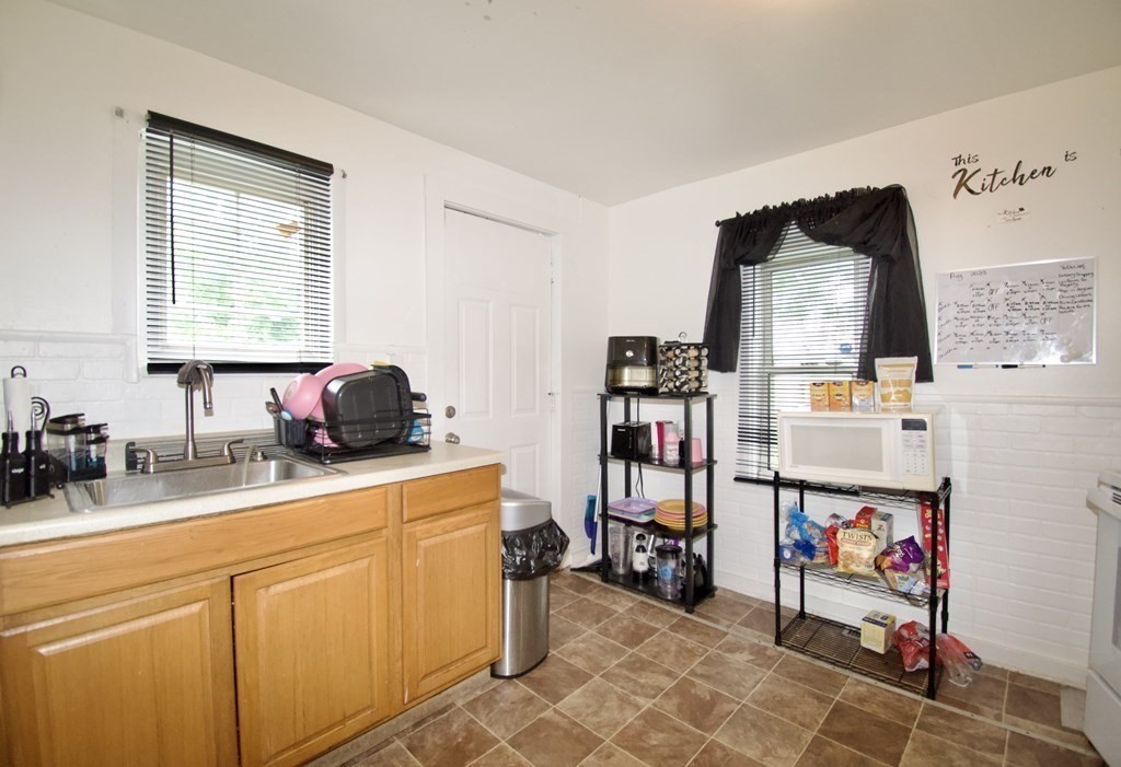 38 Collins Street Springfield, MA 01109 - Photo 23 of 39 a kitchen that has a lot of cabinets in it and a window