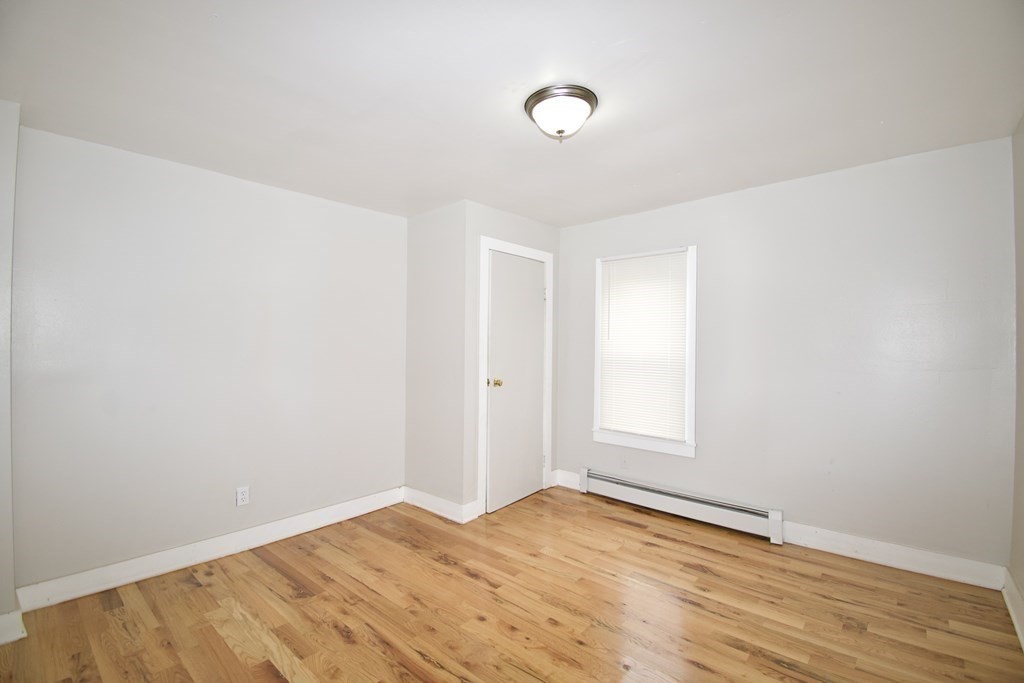 38 Collins Street Springfield, MA 01109 - Photo 5 of 39 a view of empty room with wooden floor and fan