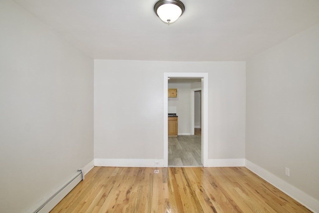 38 Collins Street Springfield, MA 01109 - Photo 6 of 39 a view of a room with wooden floor and a sink