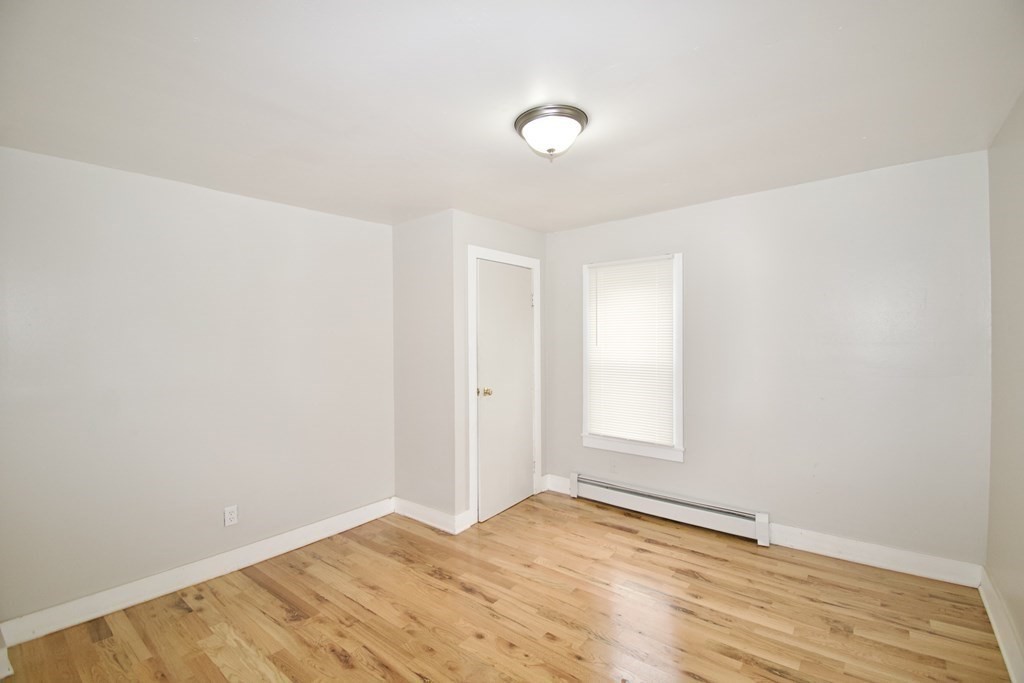 38 Collins Street Springfield, MA 01109 - Photo 7 of 39 a view of empty room with wooden floor and fan