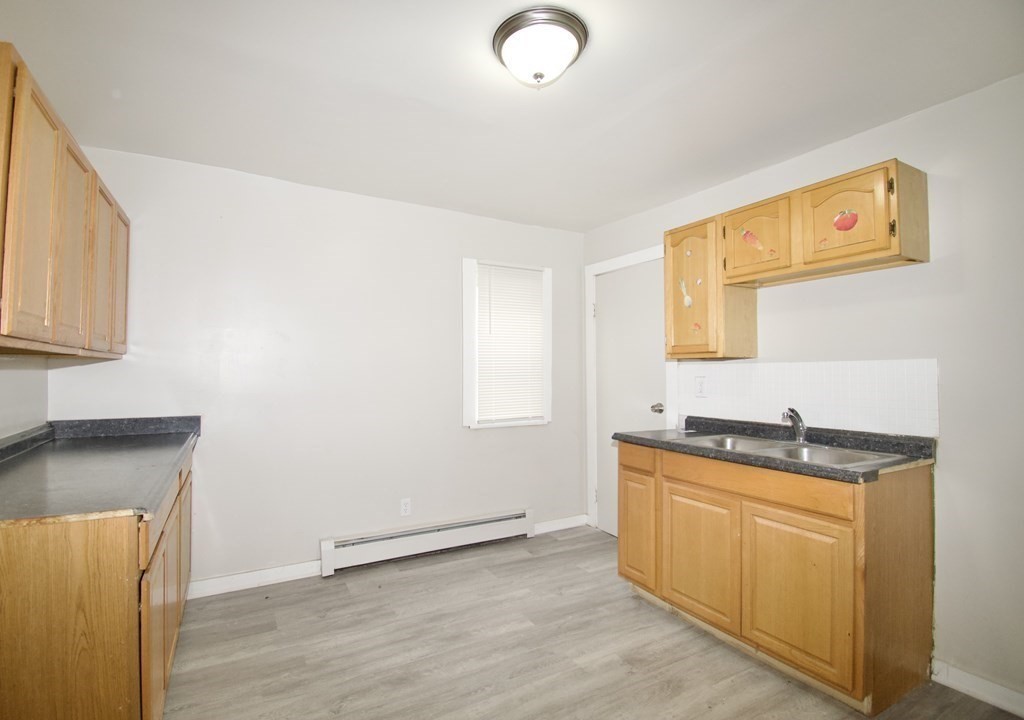 38 Collins Street Springfield, MA 01109 - Photo 8 of 39 a kitchen with sink cabinets and window