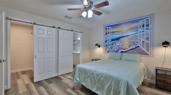 a bedroom with a bed and a chandelier