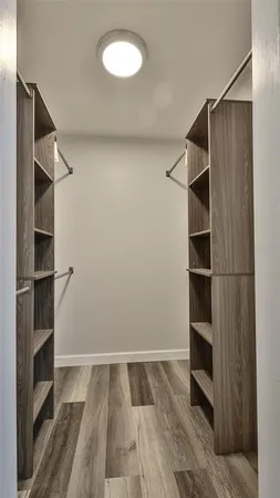 a view of walk in closet with empty racks