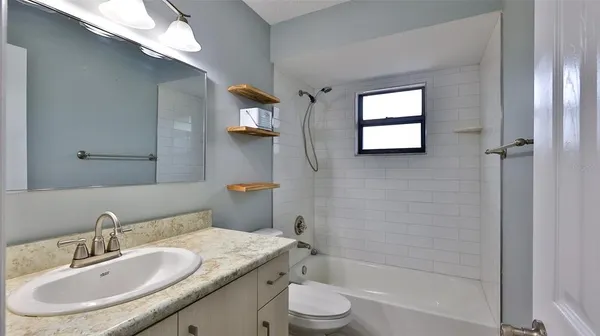a bathroom with a sink toilet tub and shower