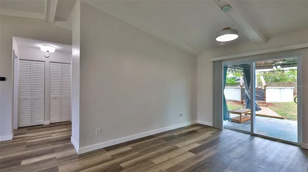 a view of an empty room and wooden floor