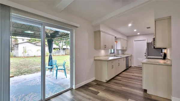 a large kitchen with granite countertop a large window and a counter space