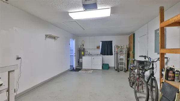 a view of a chairs and table in patio with wooden fence