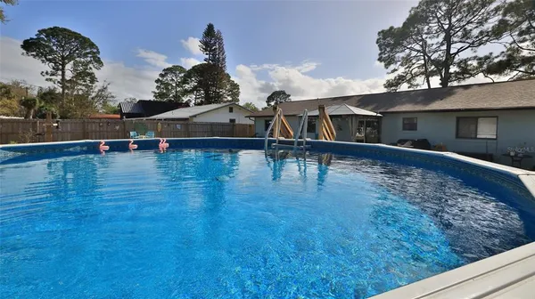 swimming pool view with a seating space