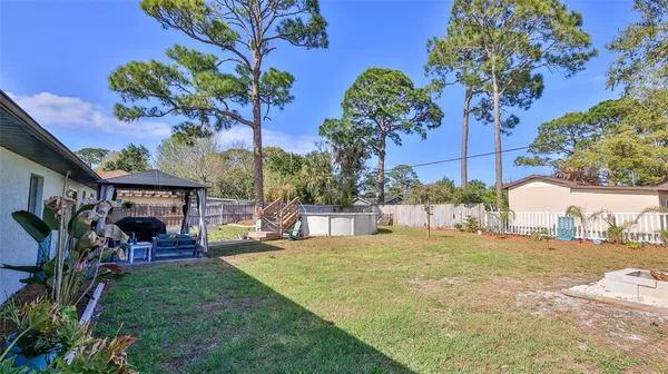 a backyard of a house with table and chairs