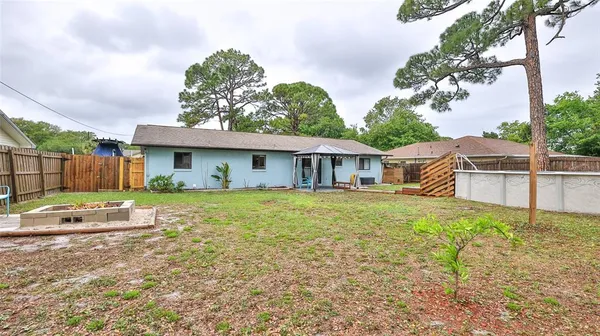 a view of a house with a yard and tree