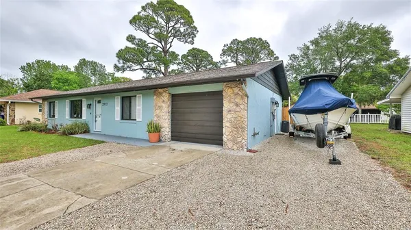 a front view of house with yard and trees