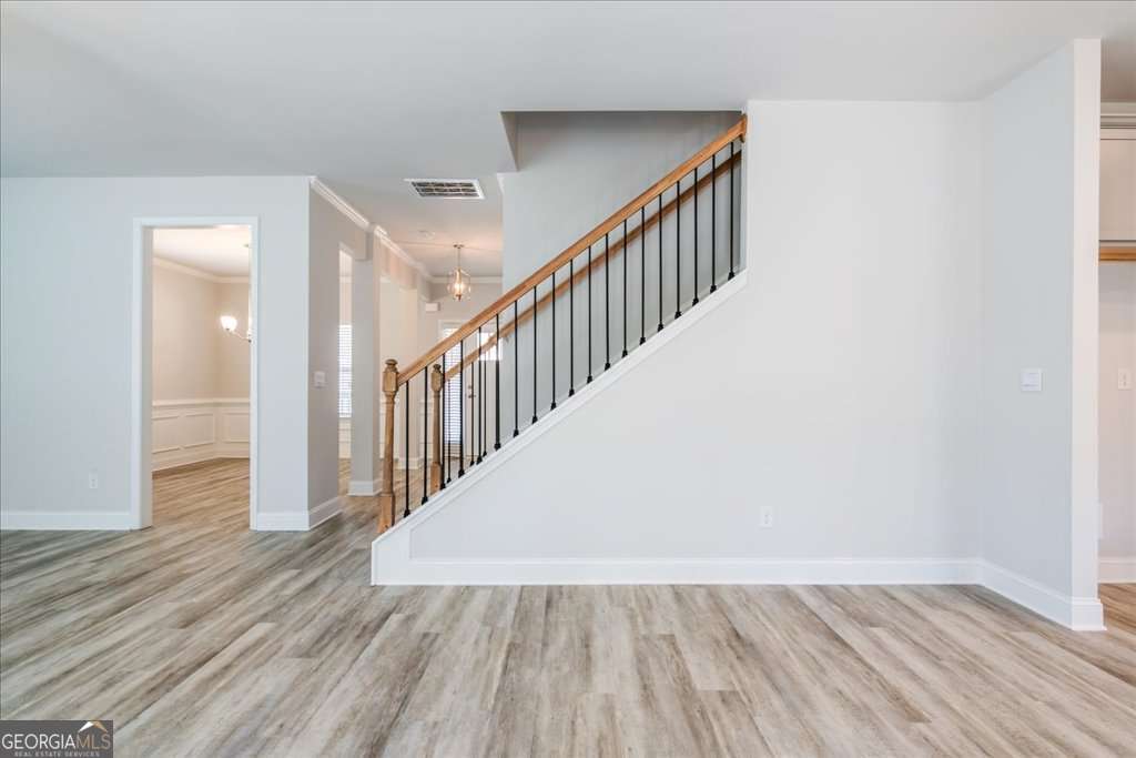 219 Carsons Walk Macon, GA 31206 - Photo 13 of 57 a view of a hallway with wooden floor and staircase