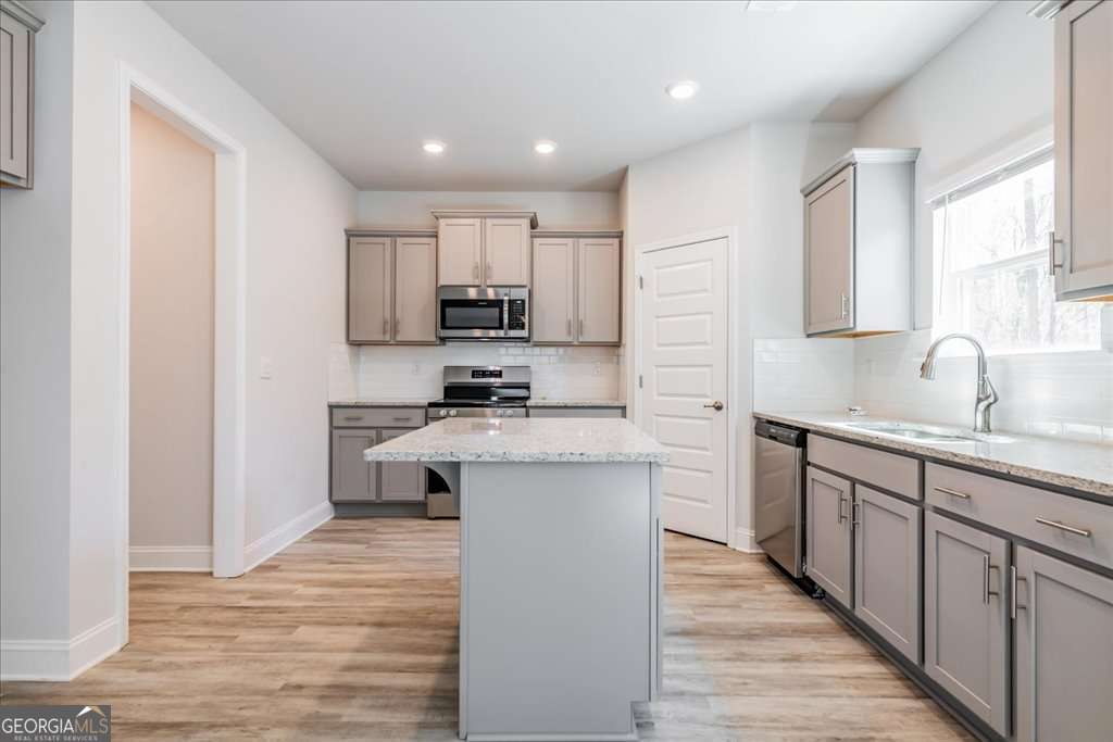 219 Carsons Walk Macon, GA 31206 - Photo 14 of 57 a kitchen with kitchen island granite countertop a sink cabinets and stainless steel appliances