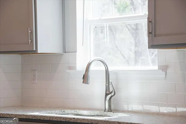 a kitchen with stainless steel appliances white cabinets and a stove top oven
