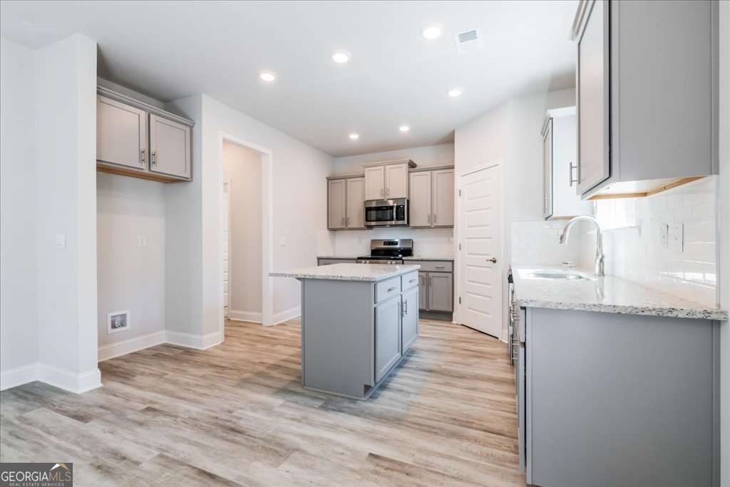 219 Carsons Walk Macon, GA 31206 - Photo 21 of 57 a kitchen with granite countertop a sink and cabinets