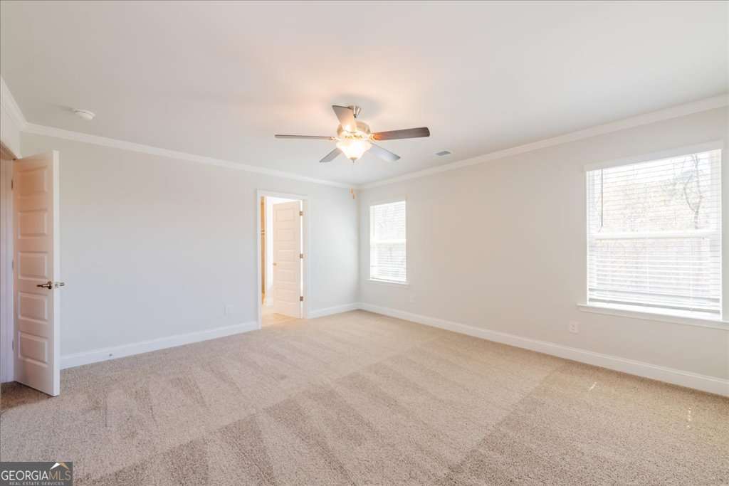 219 Carsons Walk Macon, GA 31206 - Photo 29 of 57 an empty room with windows and chandelier fan
