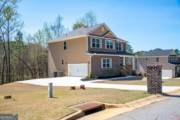 a front view of a house with a yard