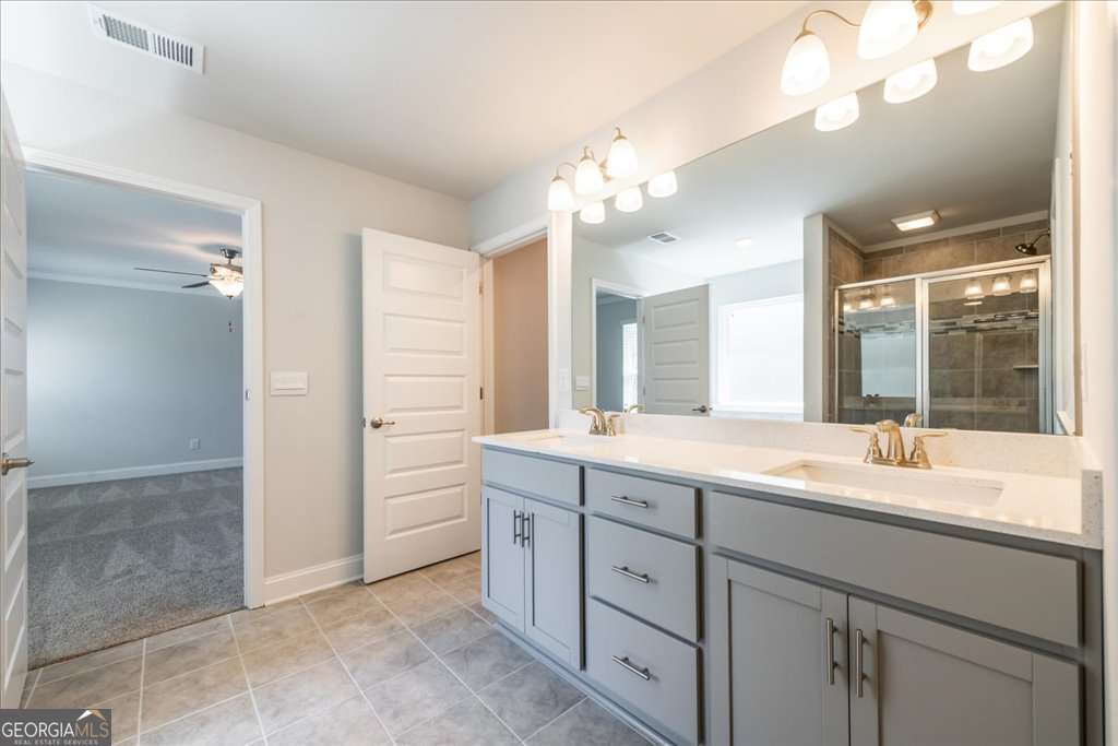 219 Carsons Walk Macon, GA 31206 - Photo 31 of 57 a bathroom with a granite countertop sink a large mirror and a shower
