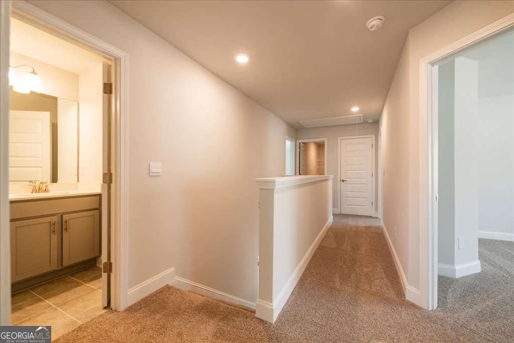 219 Carsons Walk Macon, GA 31206 - Photo 37 of 57 a view of a hallway with wooden floor and cabinet
