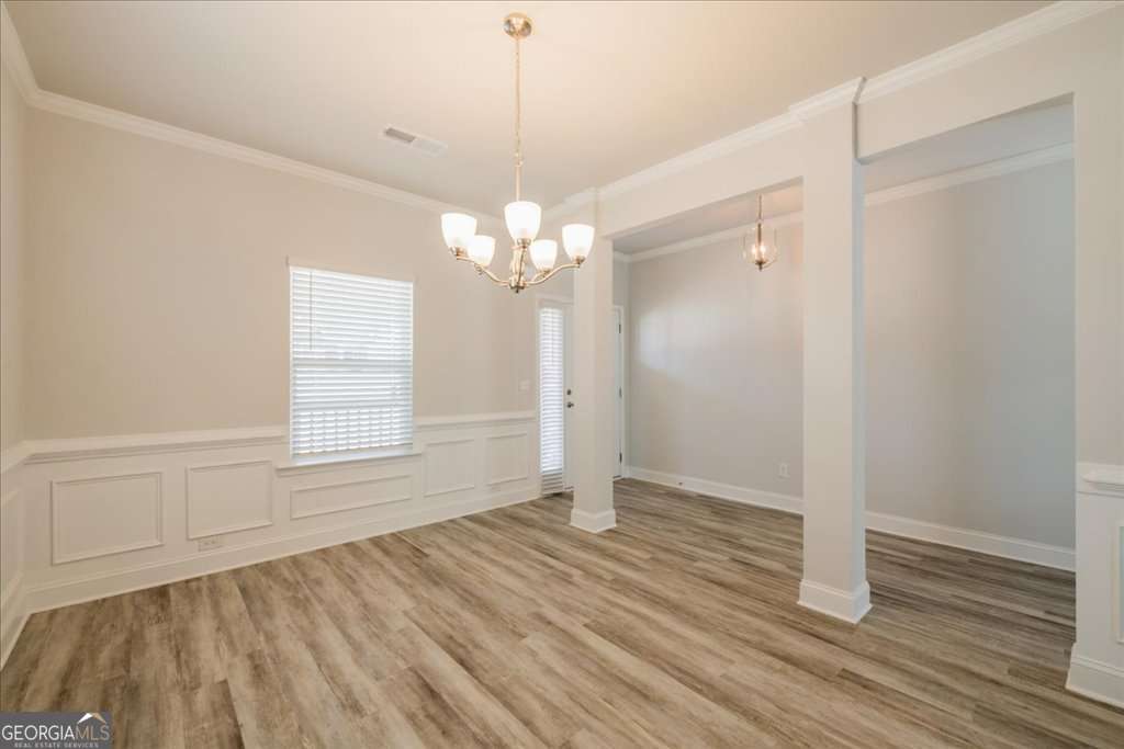 219 Carsons Walk Macon, GA 31206 - Photo 7 of 57 a view of an empty room with wooden floor and a window