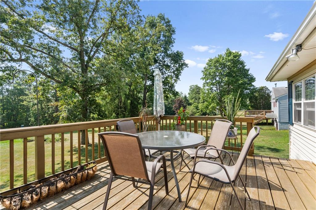 1557 Pittsburgh Road Franklin, PA 16323 - Photo 7 of 33 a view of a chairs and table on the deck