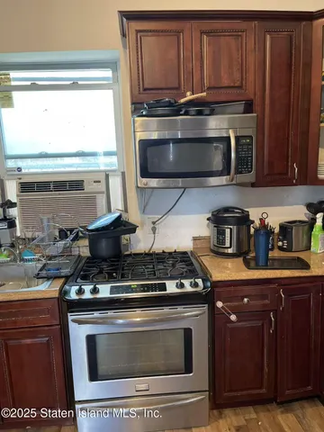 a kitchen with stainless steel appliances granite countertop a stove and a microwave