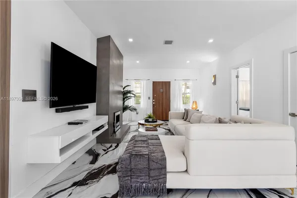 a living room with furniture and a flat screen tv