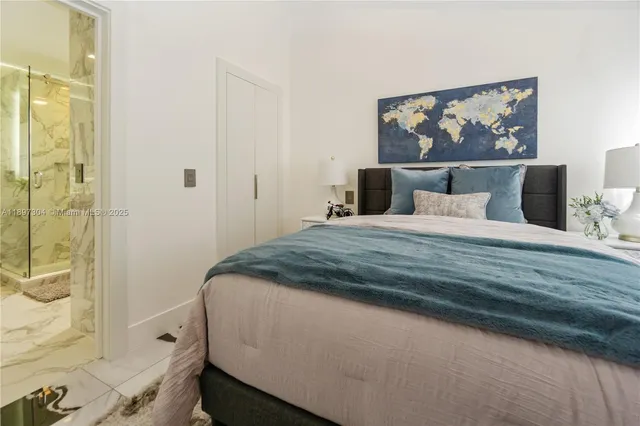 a bedroom with a bed and a painting on the wall