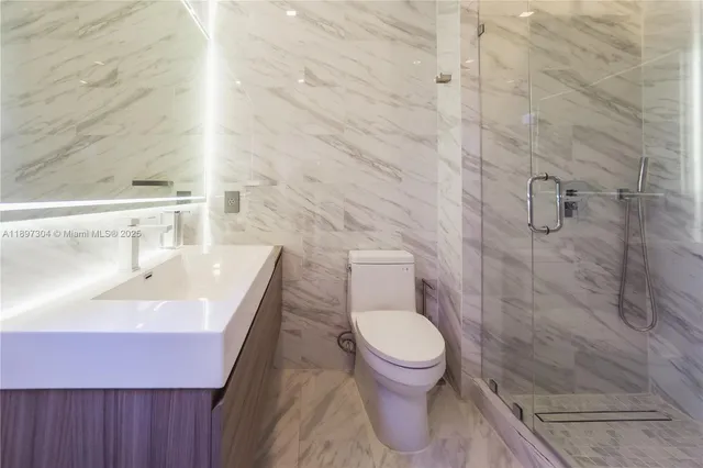a bathroom with a sink toilet and shower