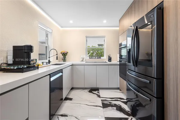 a kitchen with a refrigerator and a sink