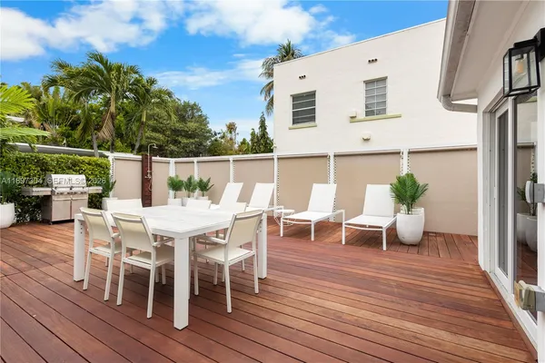 a view of a house with a patio and a yard