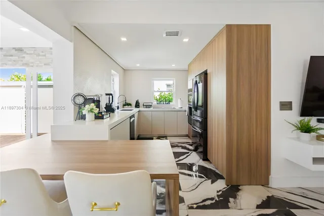 a living room with furniture a flat screen tv and a large window