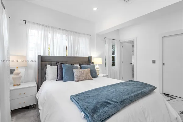 a bedroom with a bed and a painting on the wall