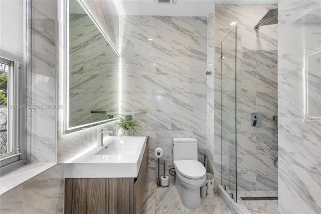 a bedroom with a bed a tv and a window