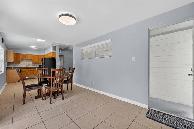a dining room with furniture and a floor to ceiling window