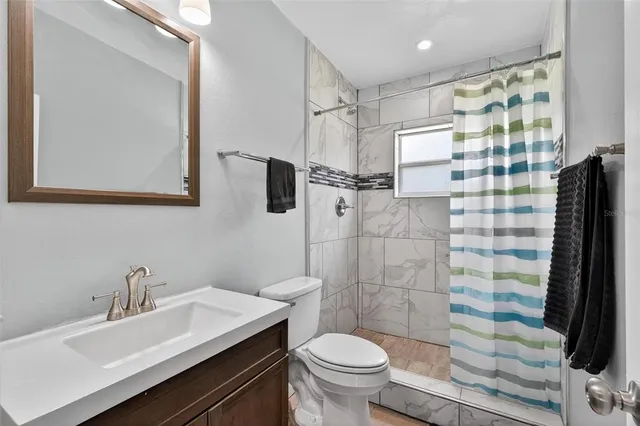 a bathroom with a shower and a toilet