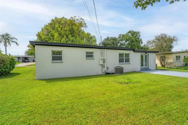 a view of a backyard with a garden and trees