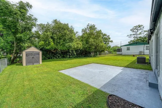a view of a garden with a house in the background