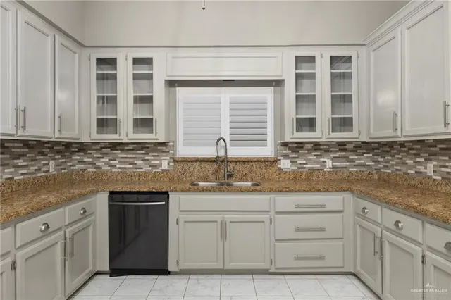 a kitchen with granite countertop appliances cabinets and a sink