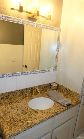 a view of an empty room with window and chandelier