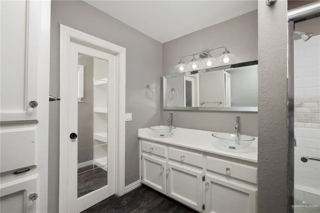 a bathroom with a shower and a mirror