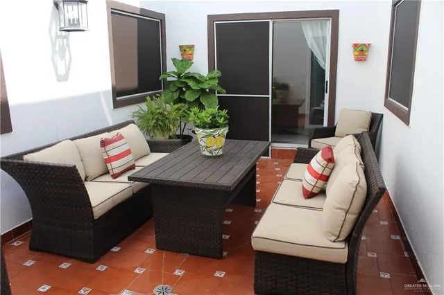 a living room with furniture and flowers