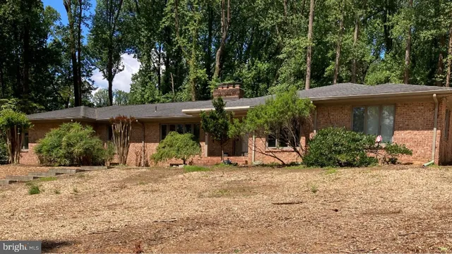 a view of a house with a yard and sitting area