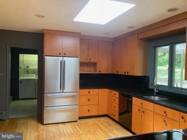 a kitchen with stainless steel appliances granite countertop a refrigerator and a sink