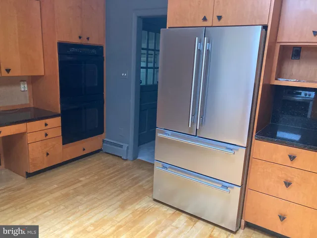 a kitchen with stainless steel appliances a refrigerator and cabinets