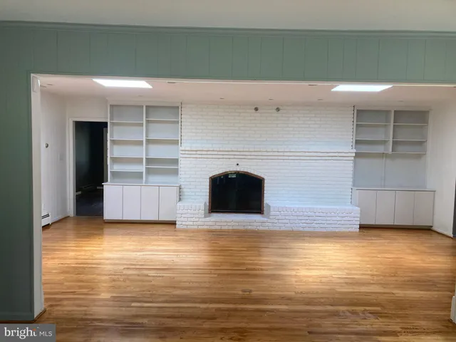 a view of a livingroom with an empty space and a fireplace