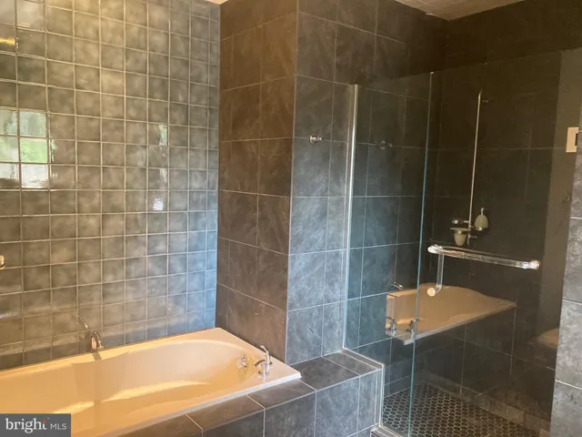a bathroom with a bathtub and shower
