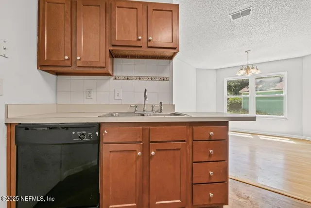 a kitchen with stainless steel appliances granite countertop cabinets and wooden floor