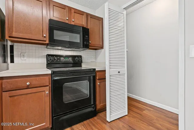 a kitchen with a stove microwave and sink