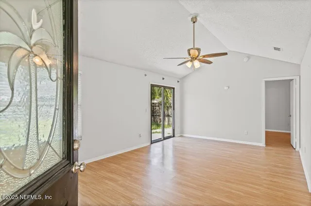 a view of an empty room with a window